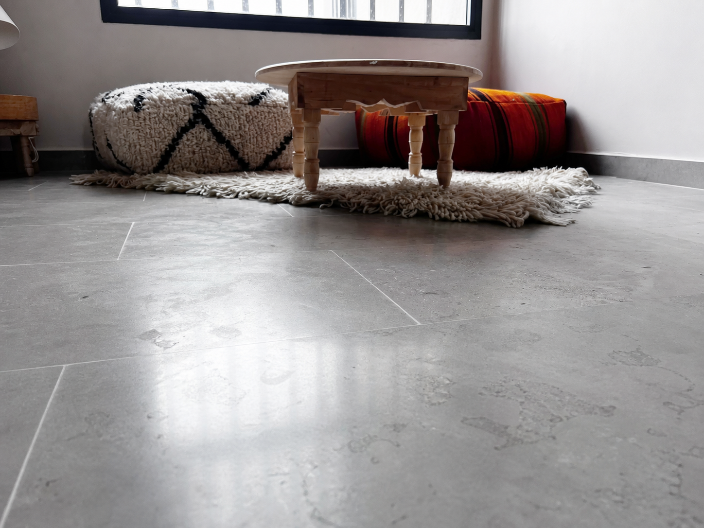Low detail of the honed floor and Moroccan furniture