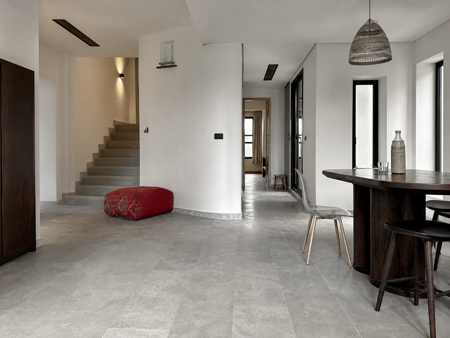 Wide view showing continuous grey limestone flooring