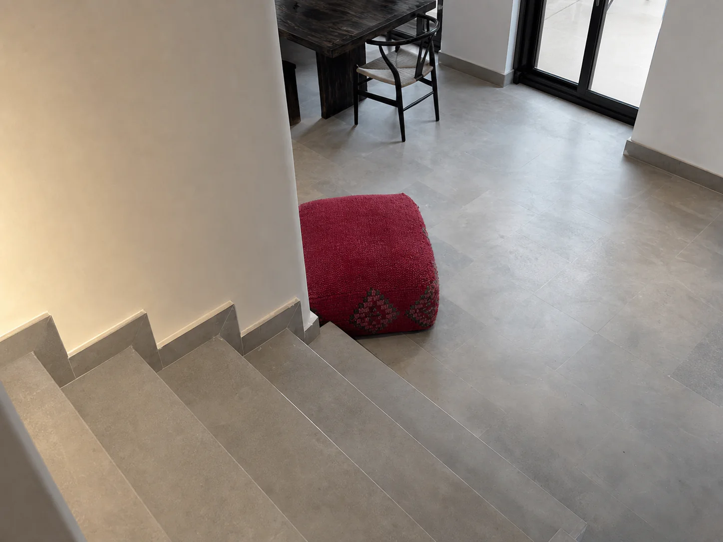 View from the stair landing toward the grey floor