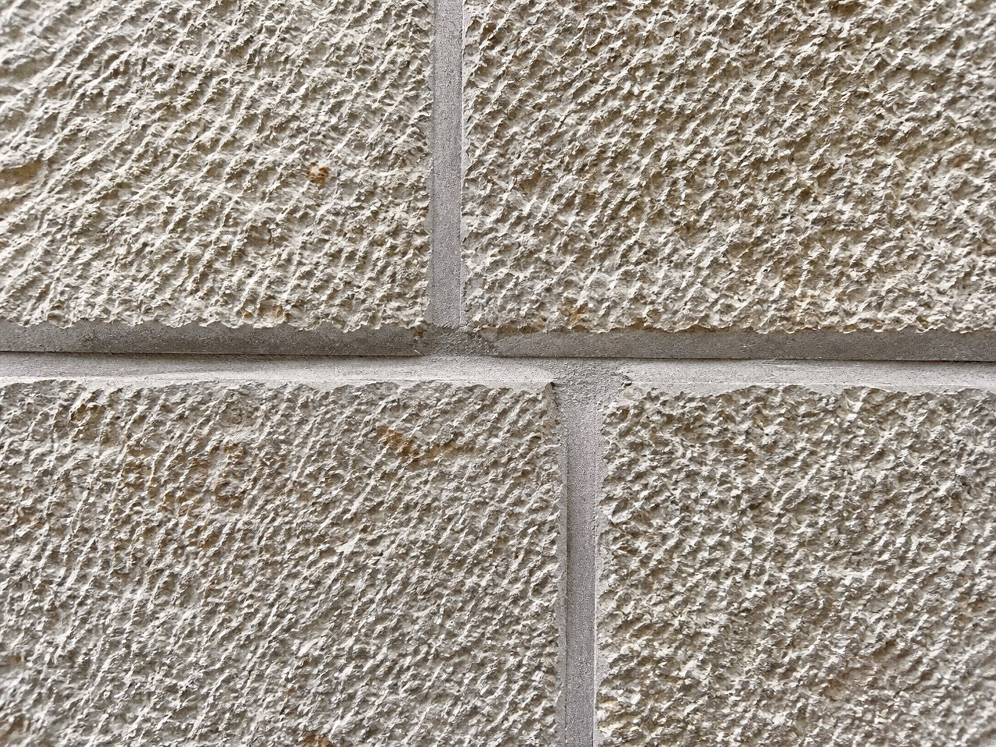 Close detail of split-face limestone and joints
