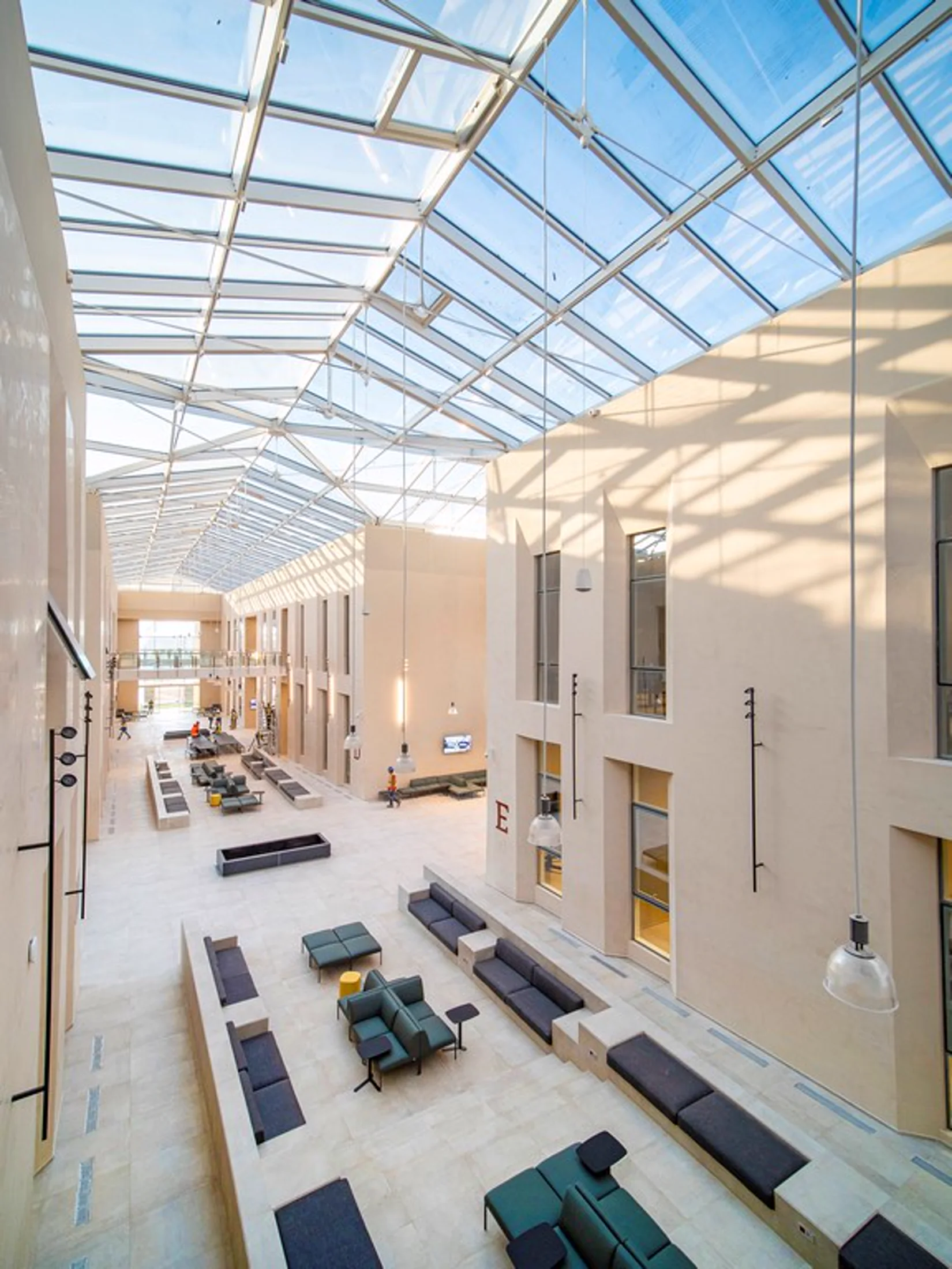 Light-filled UM6P University Rabat atrium with pale natural stone surfaces