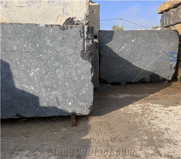 Rough dark grey natural stone blocks selected at the quarry yard