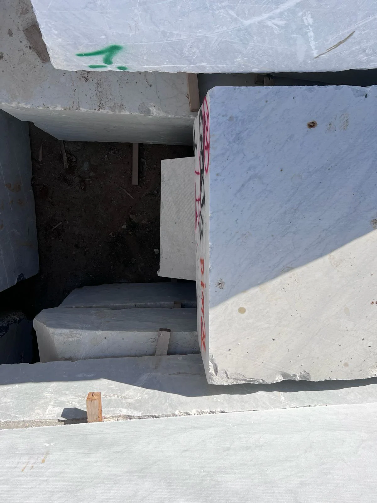 Large white marble quarry blocks marked and prepared for processing