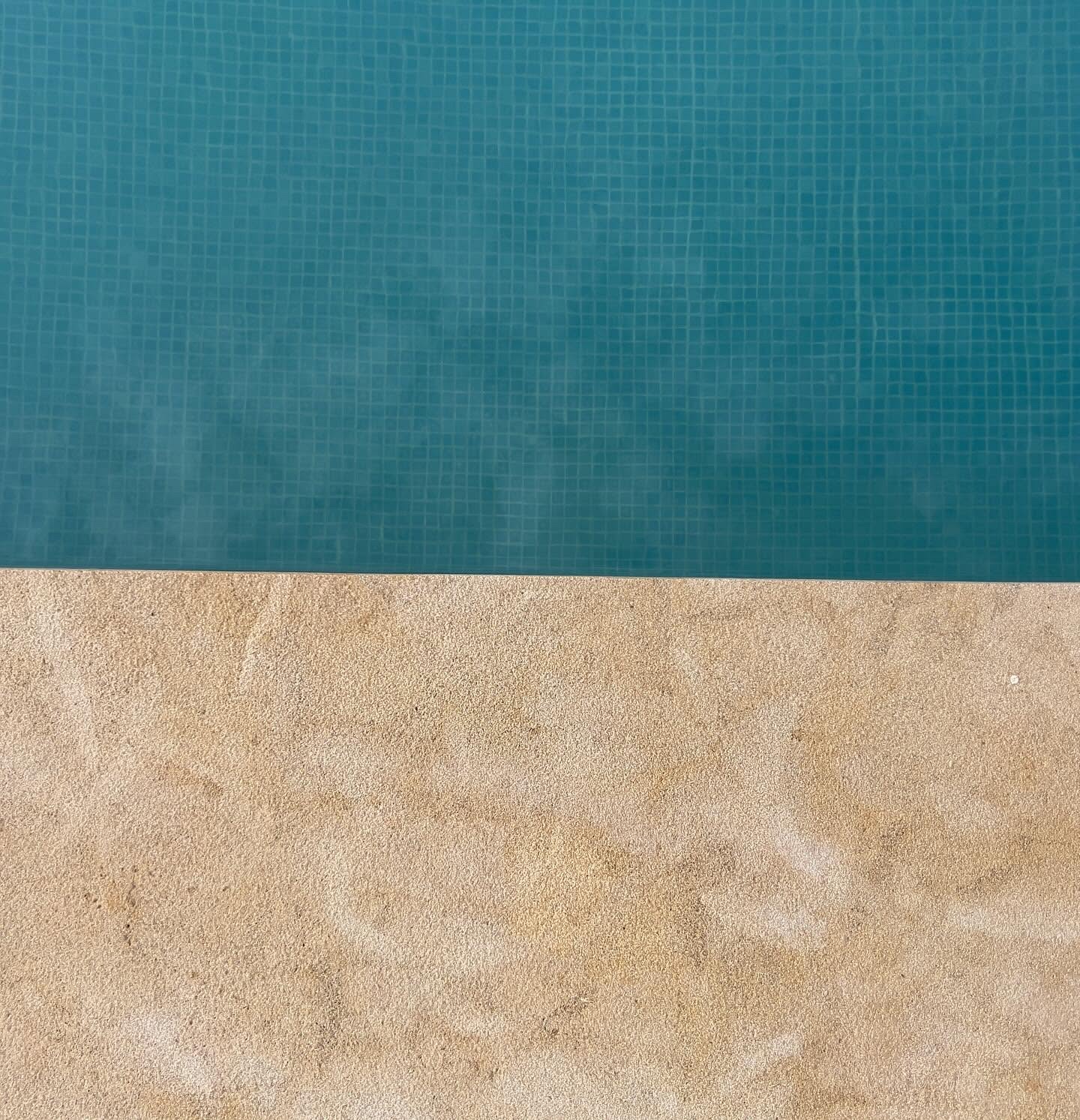 Chablis Beige limestone pool coping beside blue swimming pool water