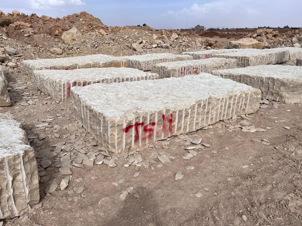 Yellow California natural stone blocks arranged at the quarry