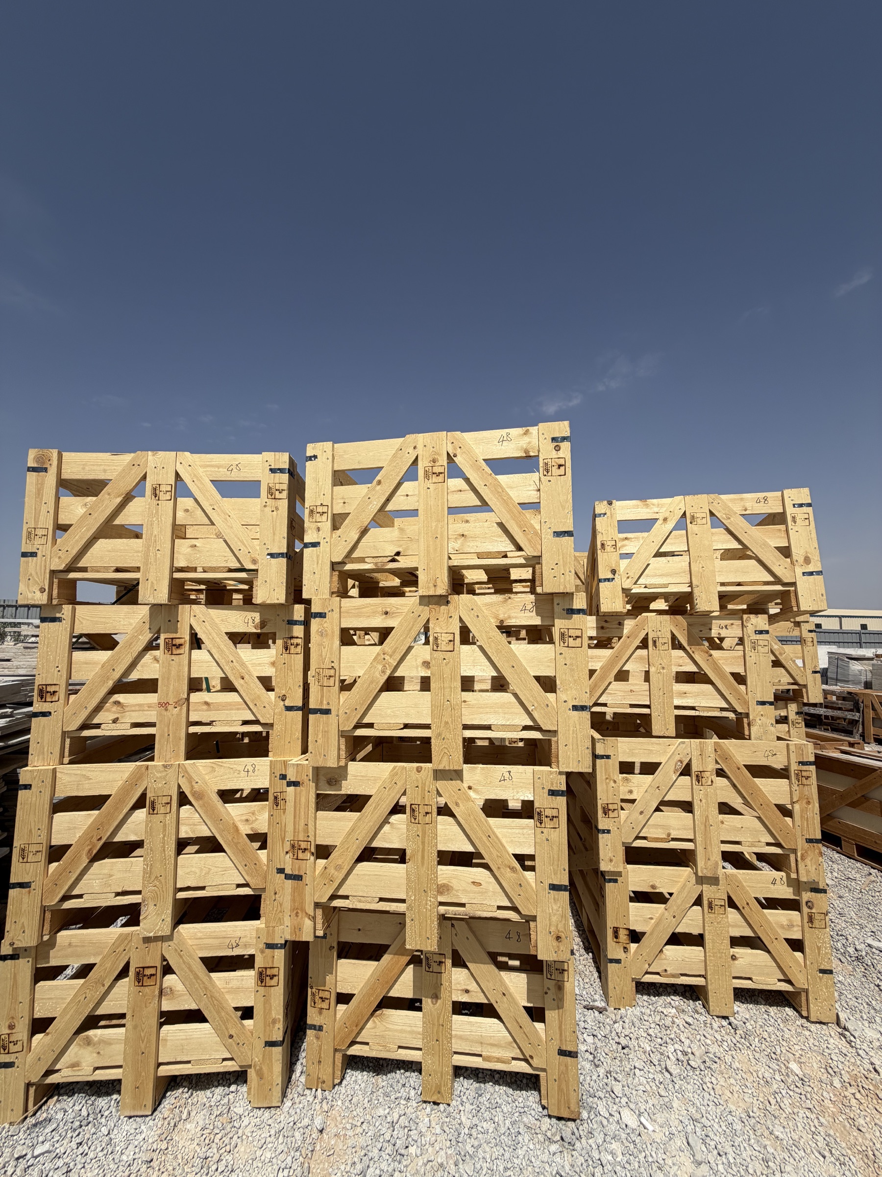 Empty timber export crates stacked in the Tesmar Stone yard