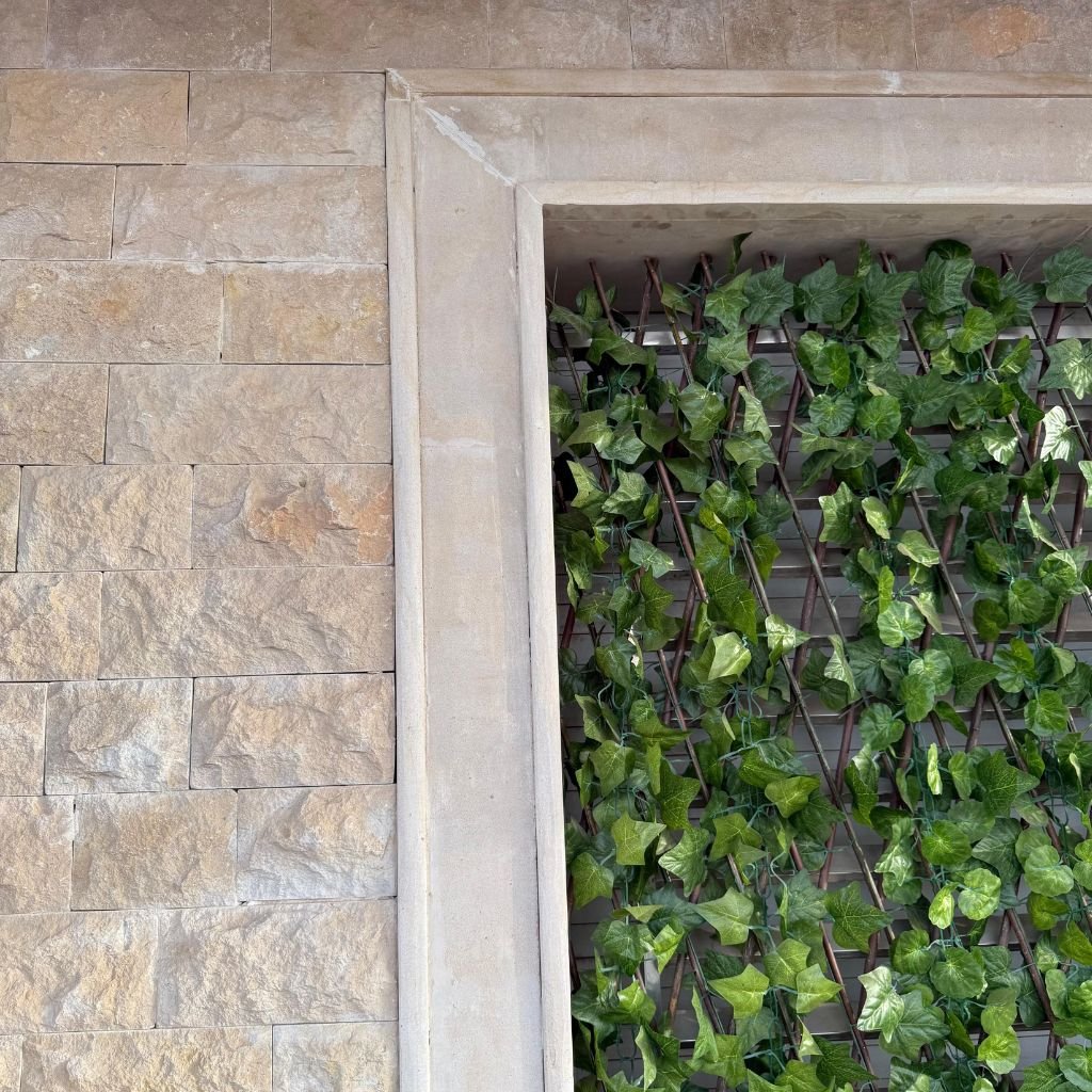 Chablis Beige rock-face walling installed beside greenery