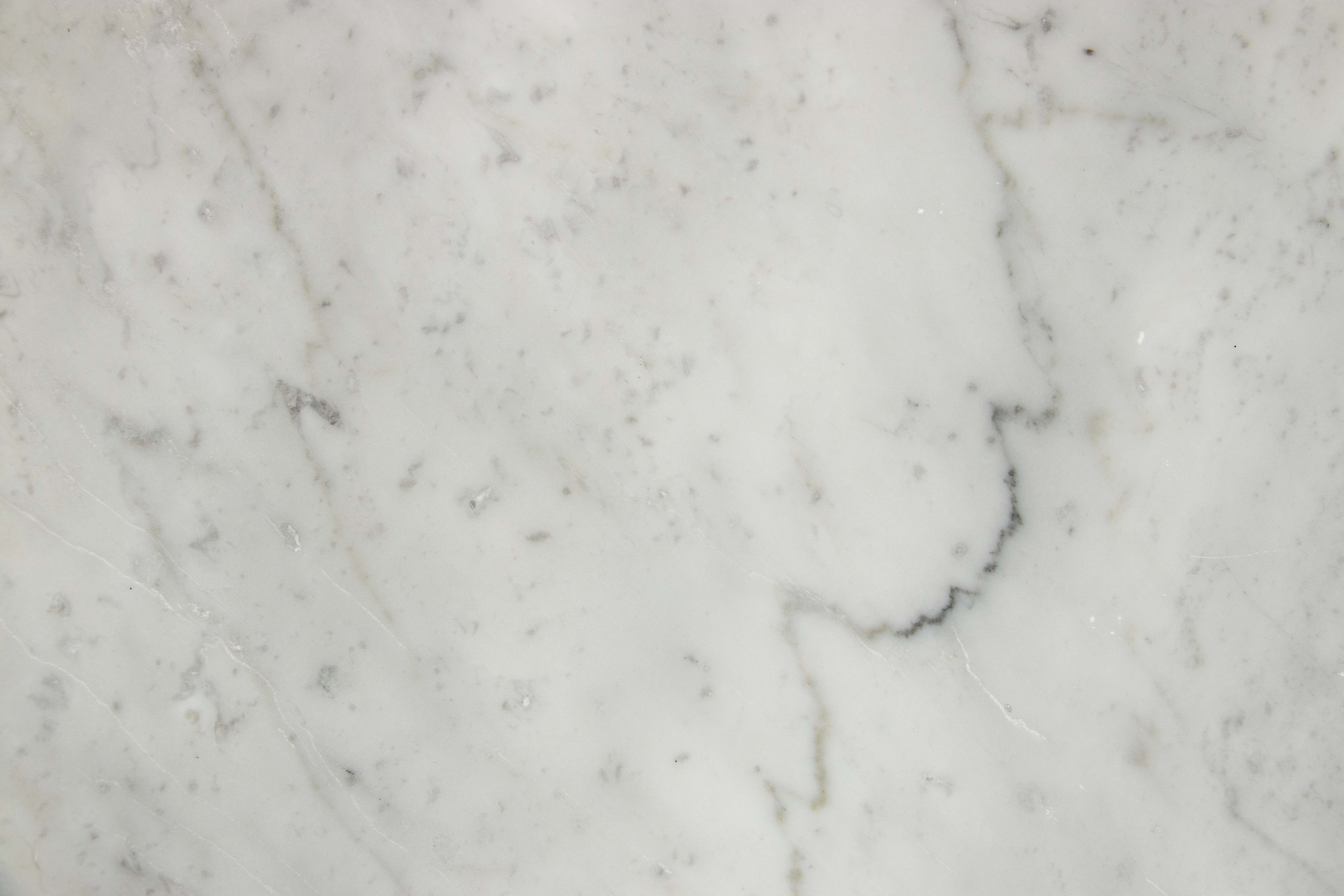 Close view of white Carrara marble with fine grey veining