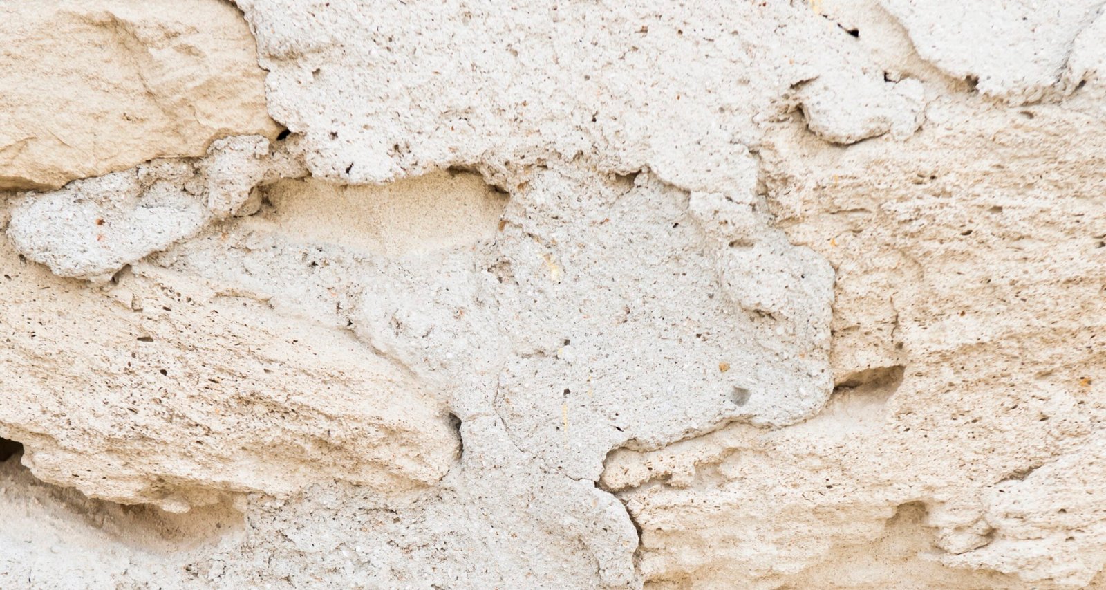 Close view of rough natural travertine with open pores and layered mineral texture